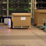 Sharko10 High Lift Pallet Robot AMR AGV with a carton box on a pallet at factory warehouse